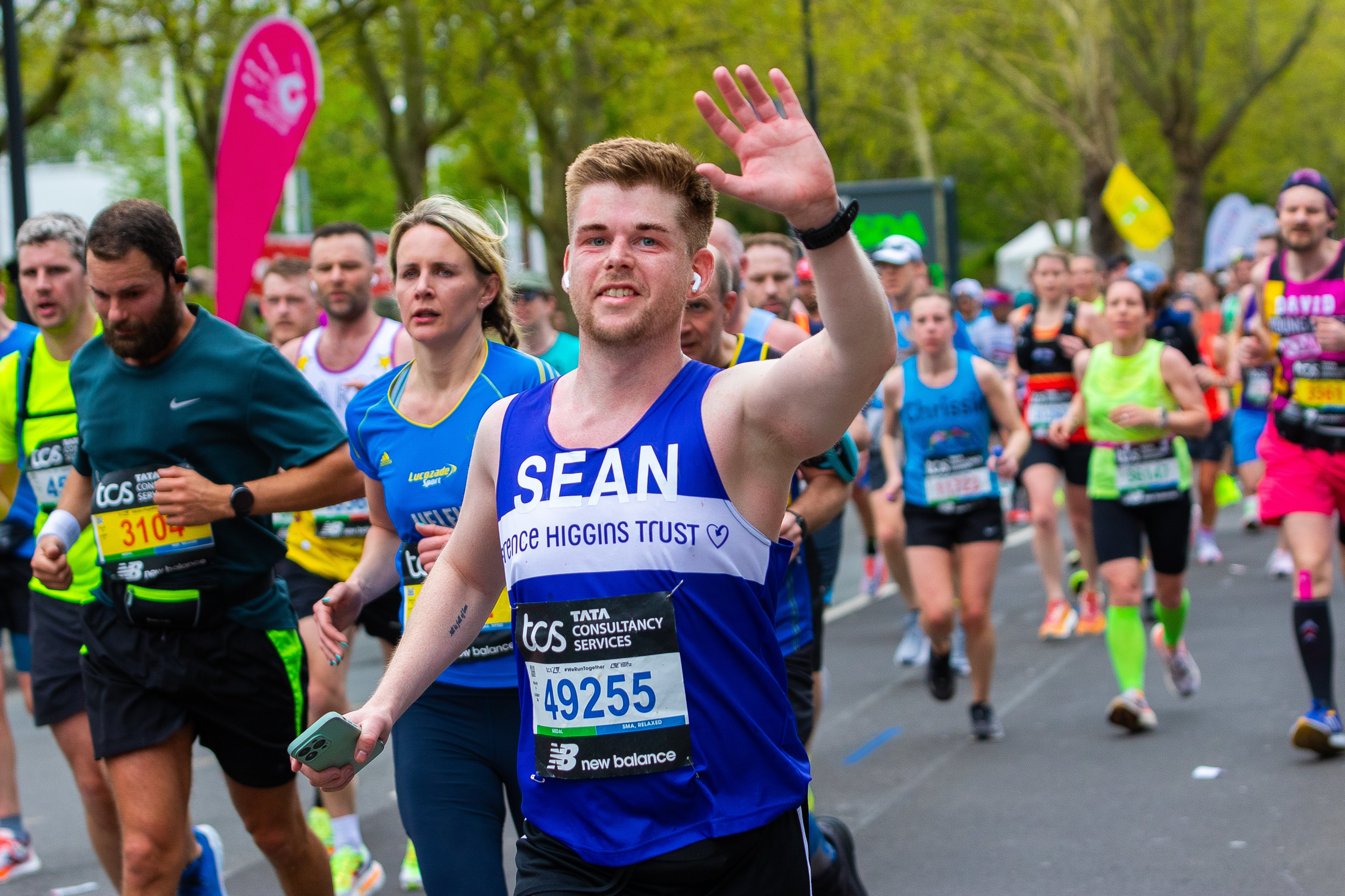 A waving Terrence Higgins Trust runner at the London Marathon.