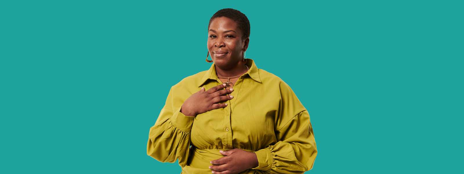 Linda in yellow outfit against a teal background