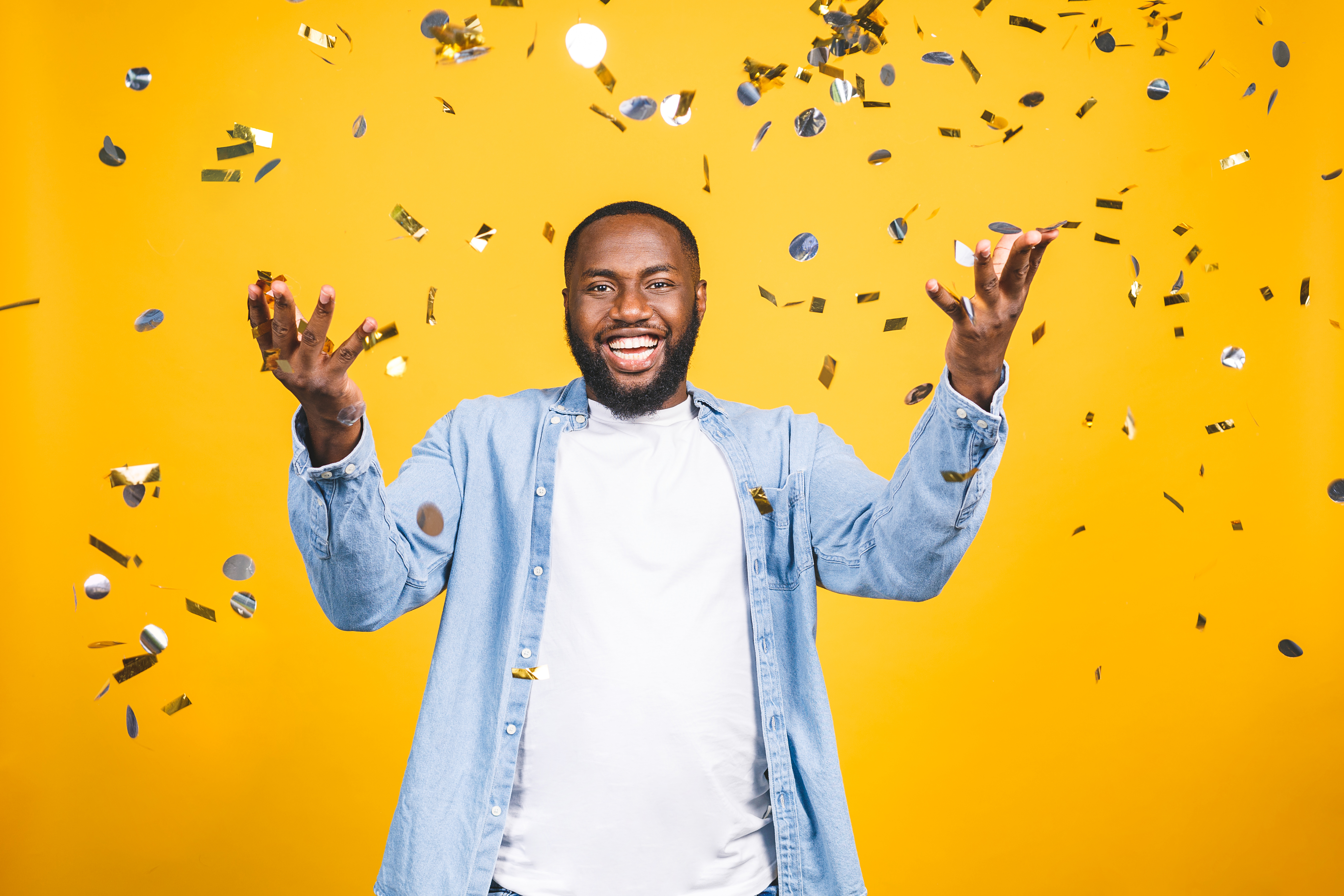 A man in a celebratory pose, smiling.