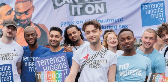 Adam from I Kissed a Boy and a group of people and Can't Pass It On banner