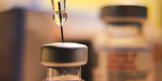 Close up of a needle within a jar.