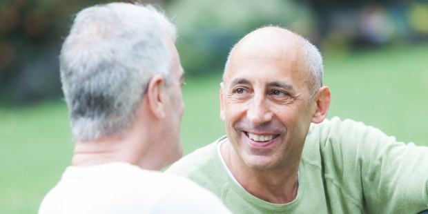 two older men chat to each other outside