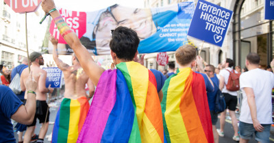 Pride marchers wearing rainbow cloaks Pride marchers wearing rainbow cloaks