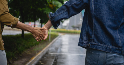 Two people holding hands