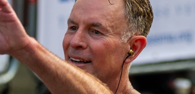 A Terrence Higgins Trust runner waving.
