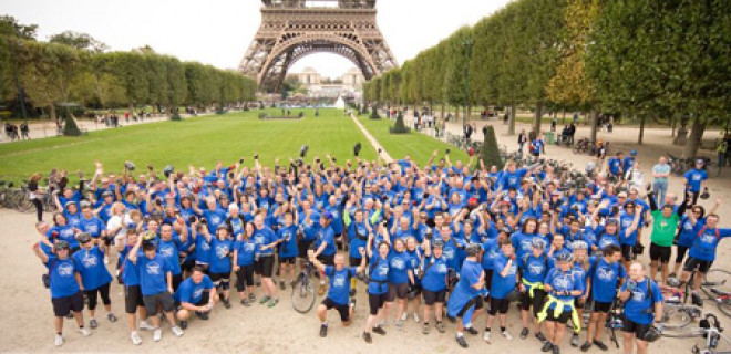 London to Paris cyclists celebrating near Eiffel Tower