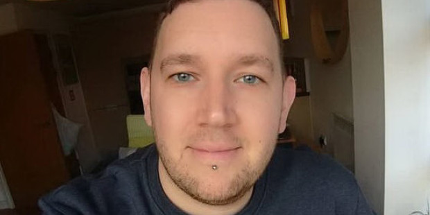 Alex Sparrowhawk smiling in a room