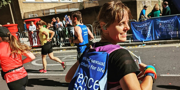Emma running London Marathon 2022 with Terrence Higgins Trust banner on back