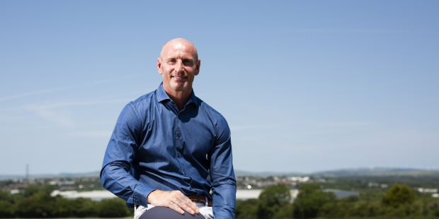 Gareth Thomas holding Tackle HIV rugby ball