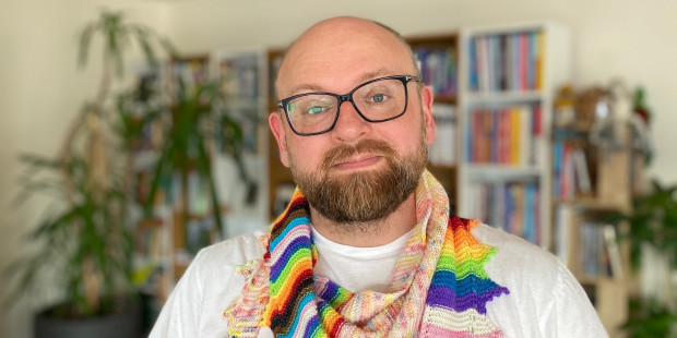 Martyn with a knitted Pride themed scarf.