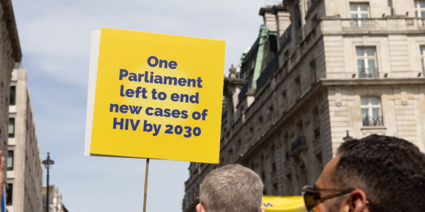 A placard held up reading "One Parliament left to end cases of HIV by 2023".