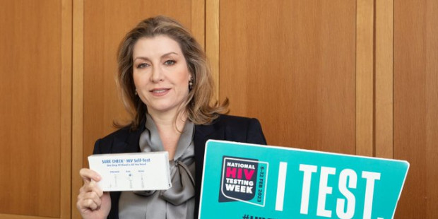 Penny Mordaunt holding up a test kit during National HIV Testing Week