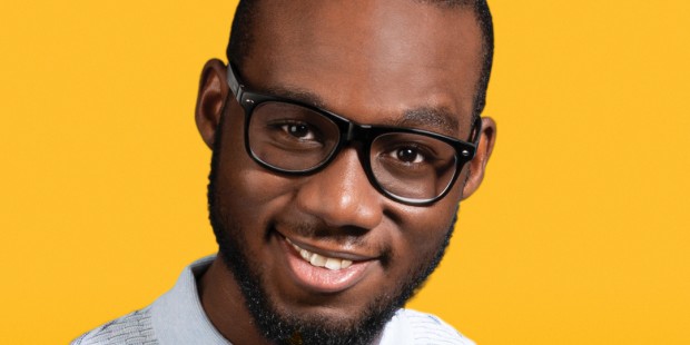 Man in glasses with yellow background