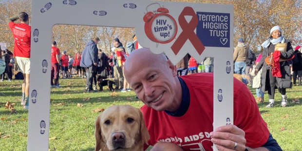 Runner with dog holding a large frame.