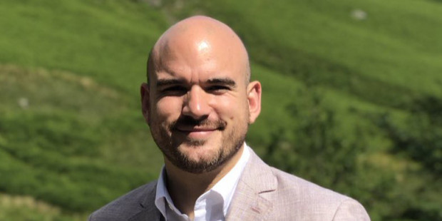 Richard Angell in front of green hills