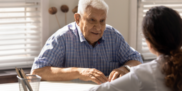 An older man talks to a doctor
