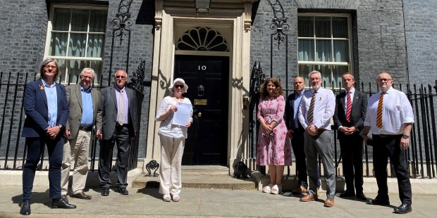 Representatives of multiple organisations outside 10 Downing Street with letter to Prime Minister