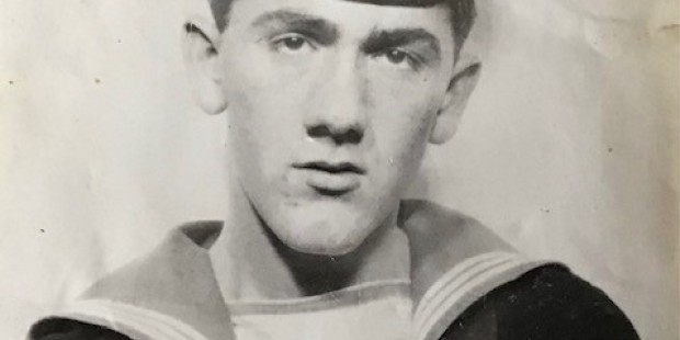 Terry Higgins. Black whit photo of a young Terry Higgins in a Navy uniform.
