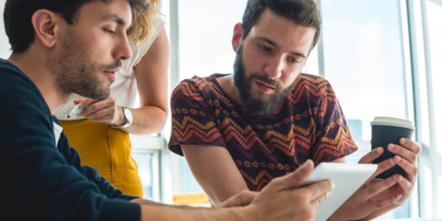 Three young people browsing tablet
