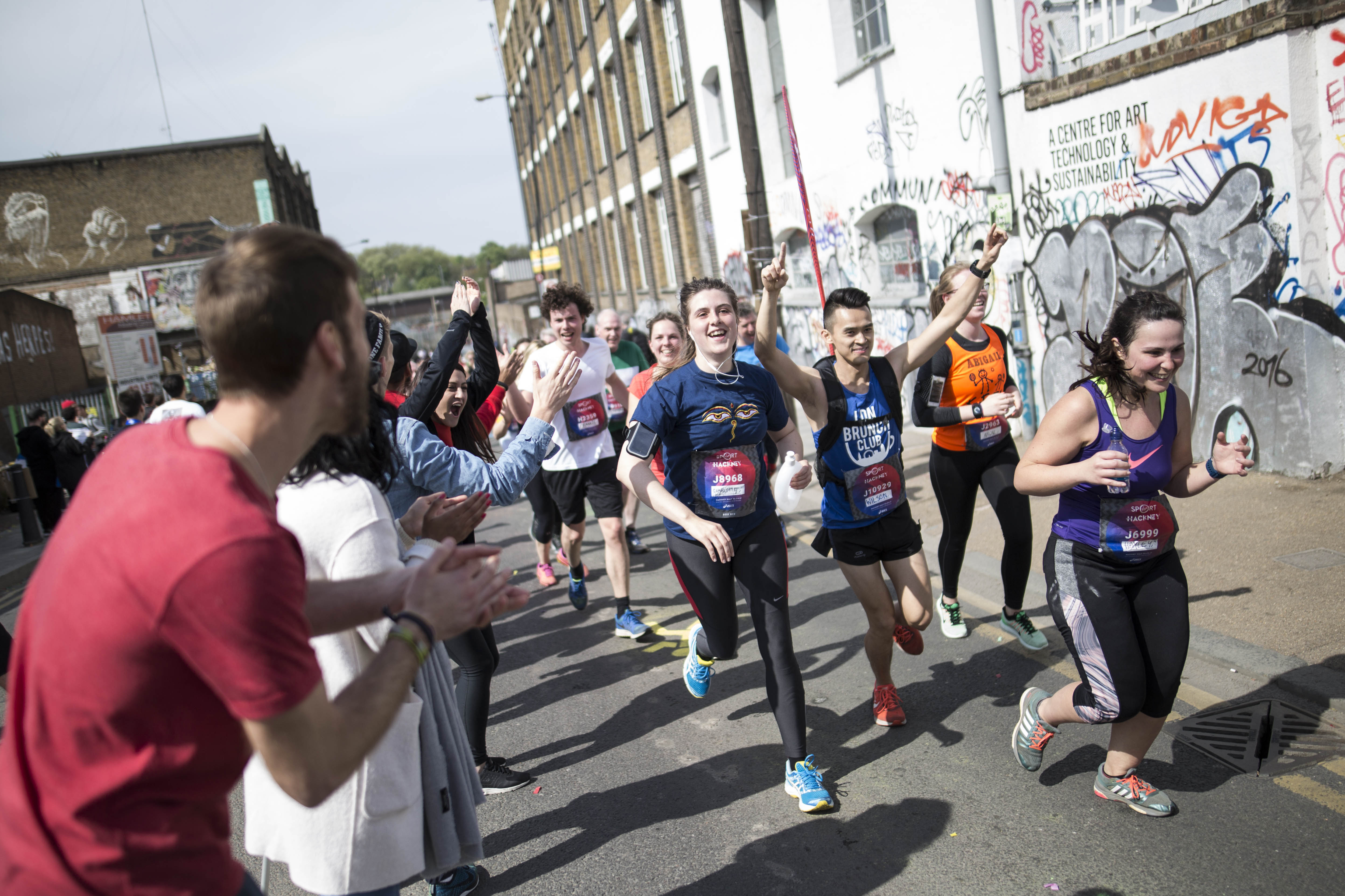 Runners in the Hackney Half Marathon being cheered on